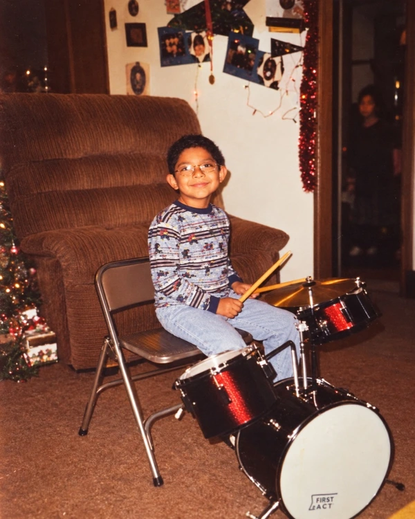 Chris as a kid at his first drum kit, Christmas 1999